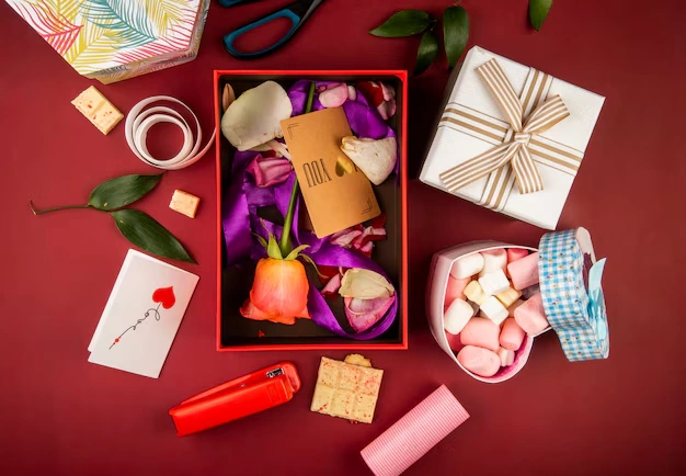 gift-boxes-floral-arrangement-cards-and-sweets-on-table