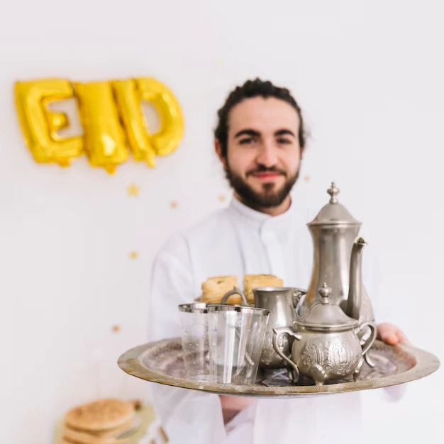 person-holding-tray-with-tea-set-and-pastries-celebrating-eid-with-eid-decor