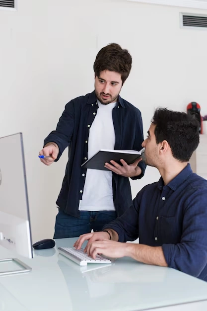 two-colleagues-discussing-eid-catering-order-on-computer-screen